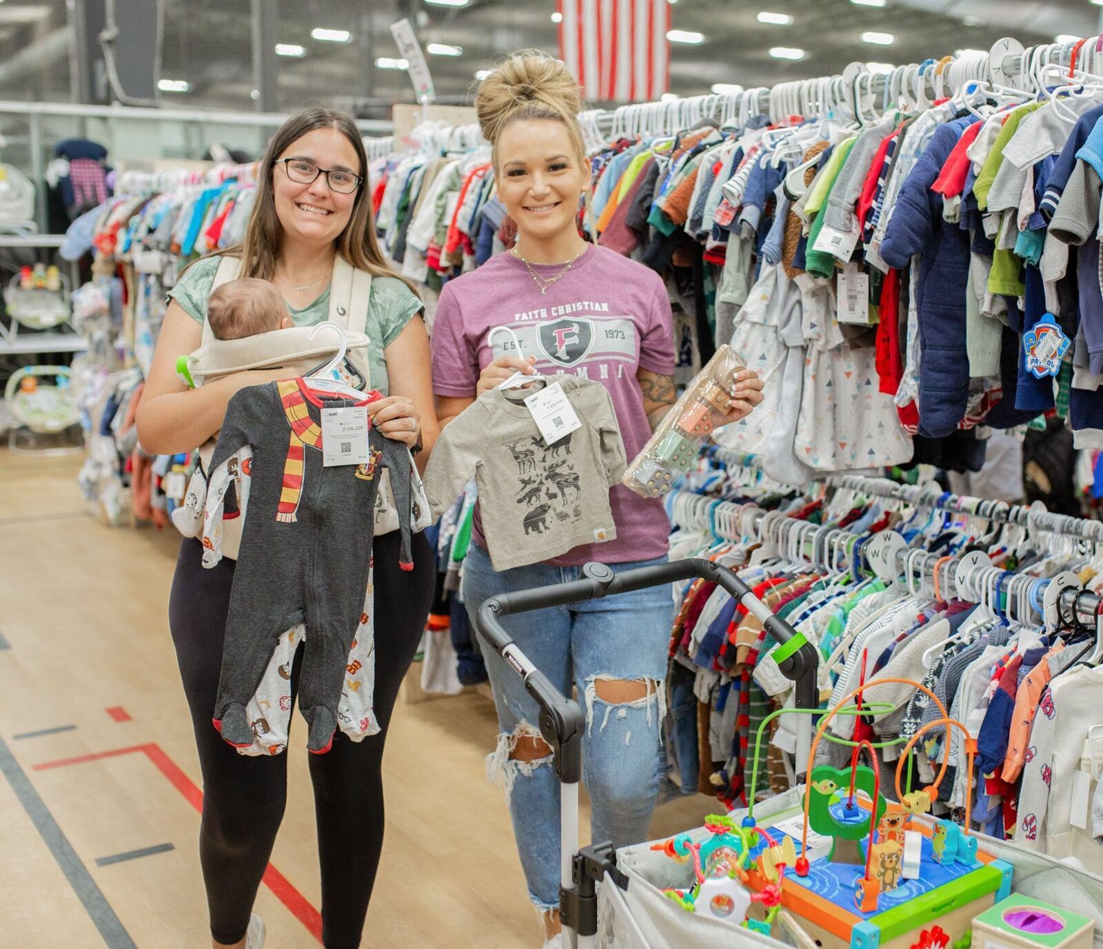 A mom, abuela and granddaughter attend a JBF sale in Dallas. Abuela is holding a babyseat.
