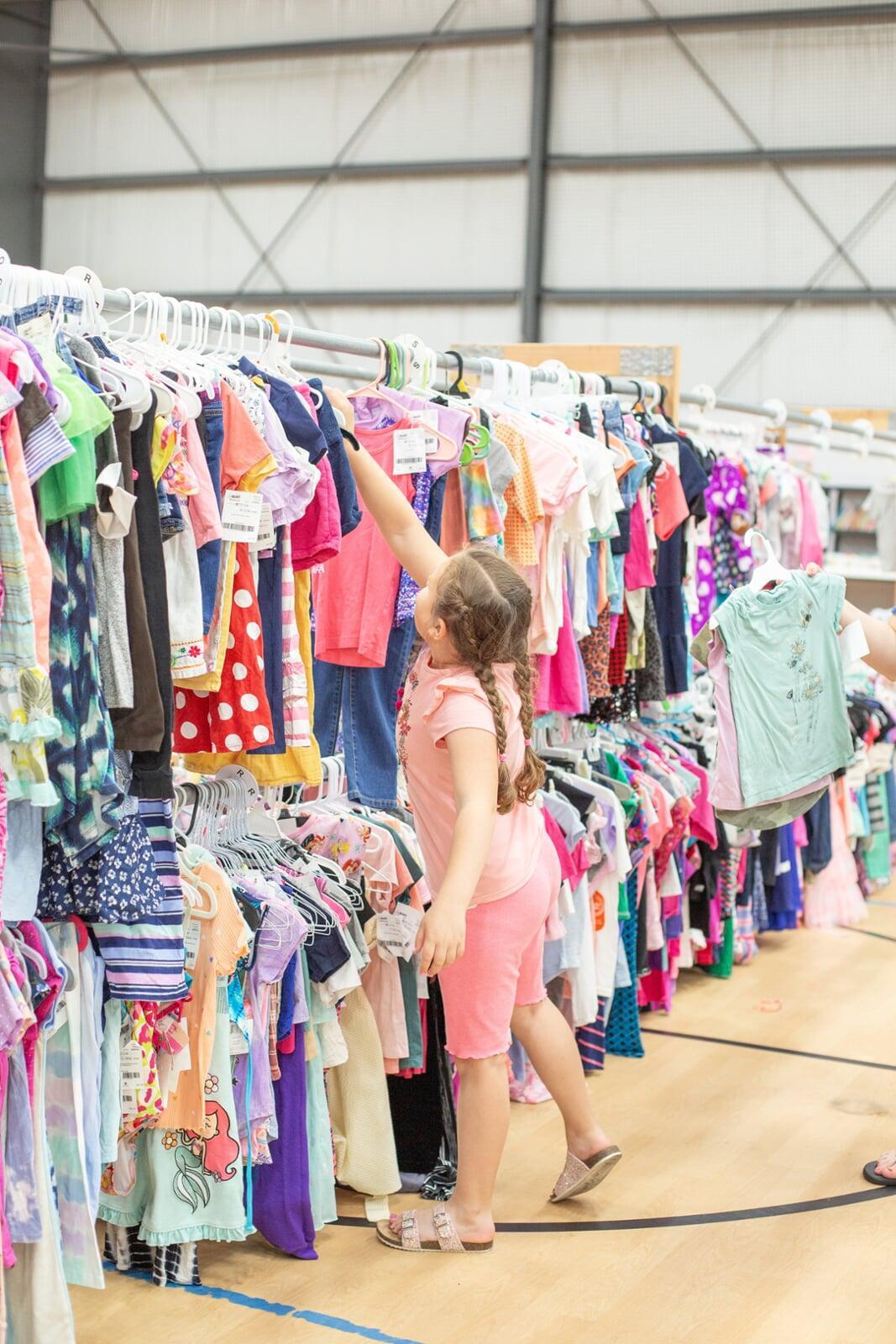 Little girl reaching for shirt